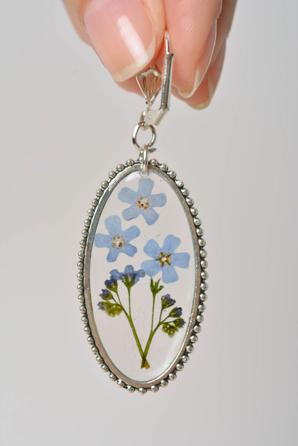 Handmade oval transparent dangle earrings with blue dried flowers in epoxy resin photo 2