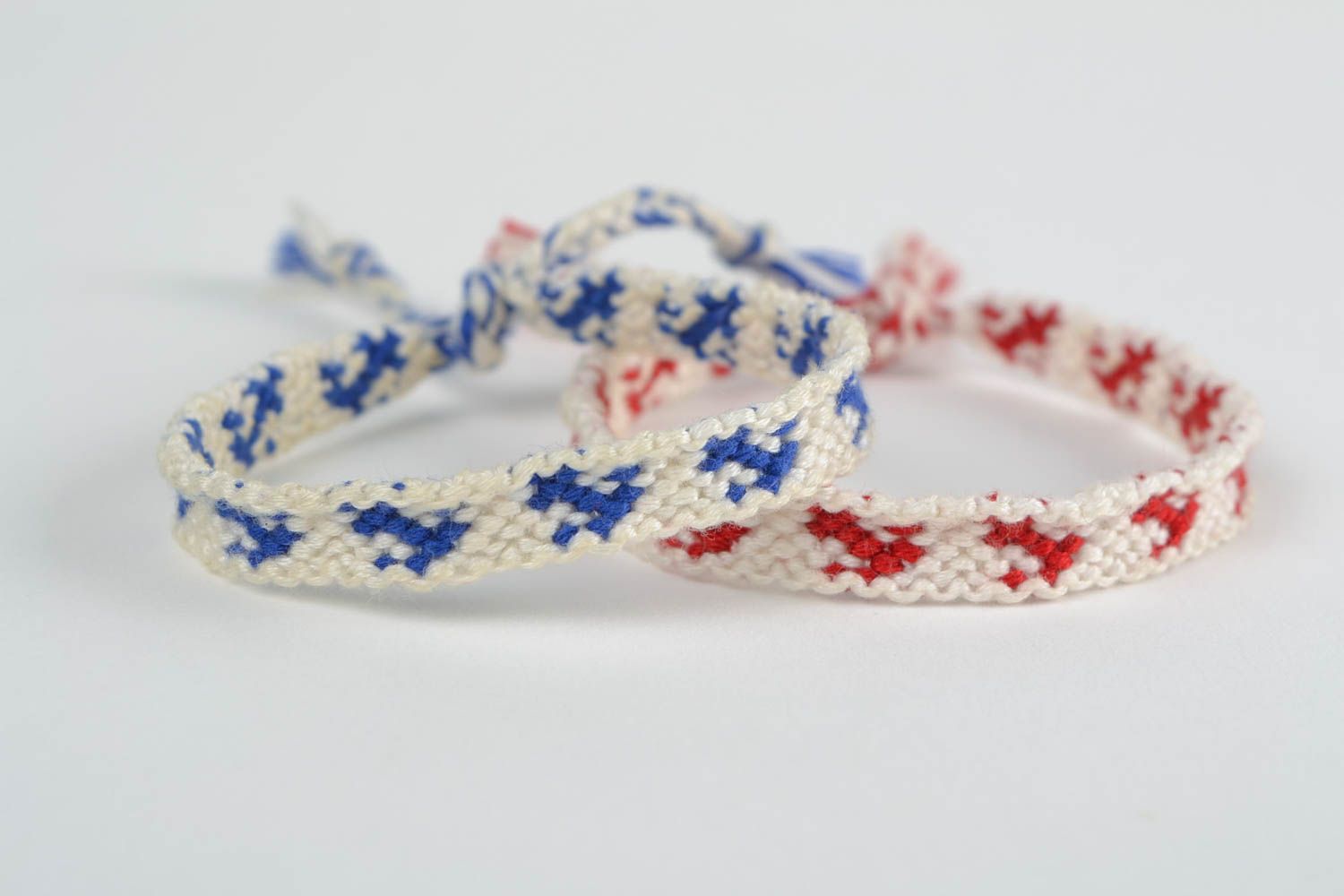 Set of 2 handmade white friendship wrist bracelets with red and blue inserts photo 3