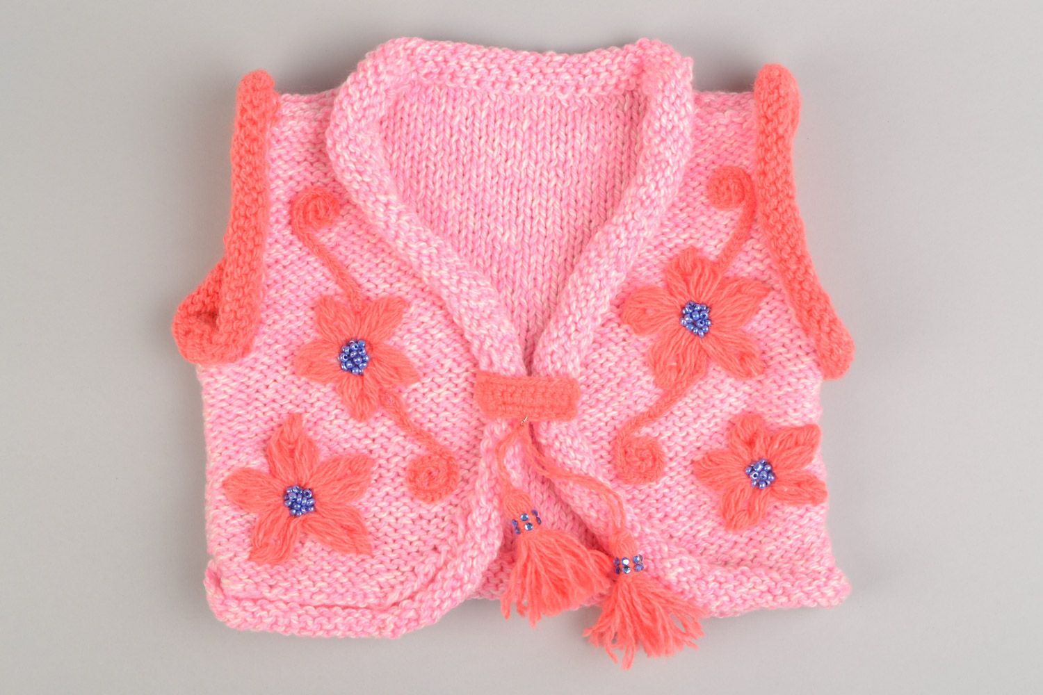 Handmade knitted vest for baby in pink color made of acrylic yarns with tassels photo 1