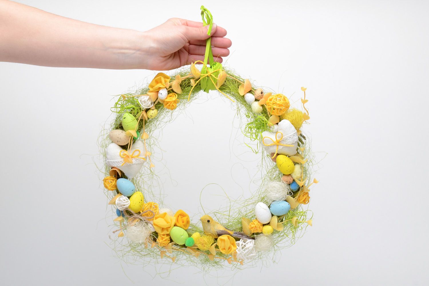 Handmade decorative Easter door wreath with little colorful eggs and feathers photo 5