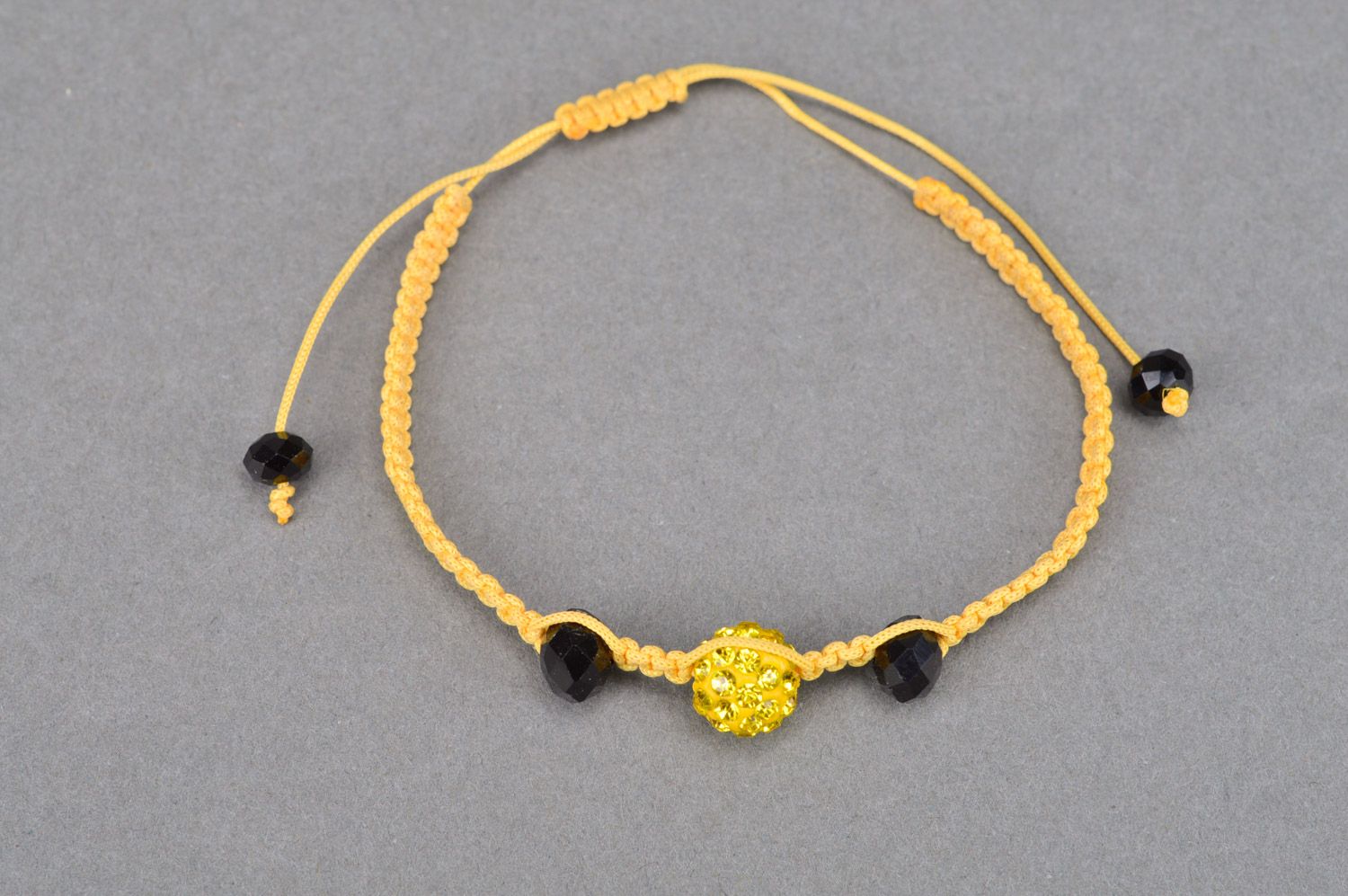 Stylish gentle handmade wrist bracelet woven of yellow threads and black beads photo 5