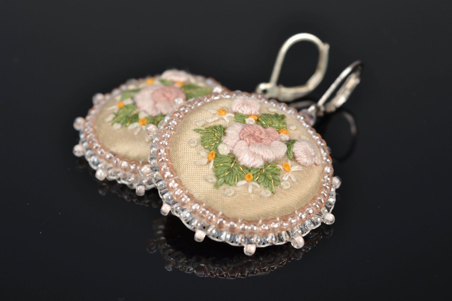 Round embroidered earrings on leather basis photo 1