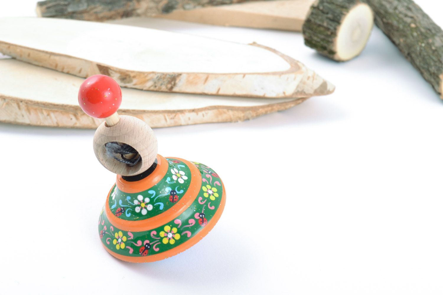 Homemade wooden ornamented toy spinning top painted with eco dyes for children photo 1
