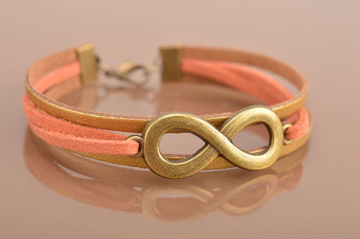 Beautiful handmade woven suede cord bracelet of gold color with insert Infinity photo 2