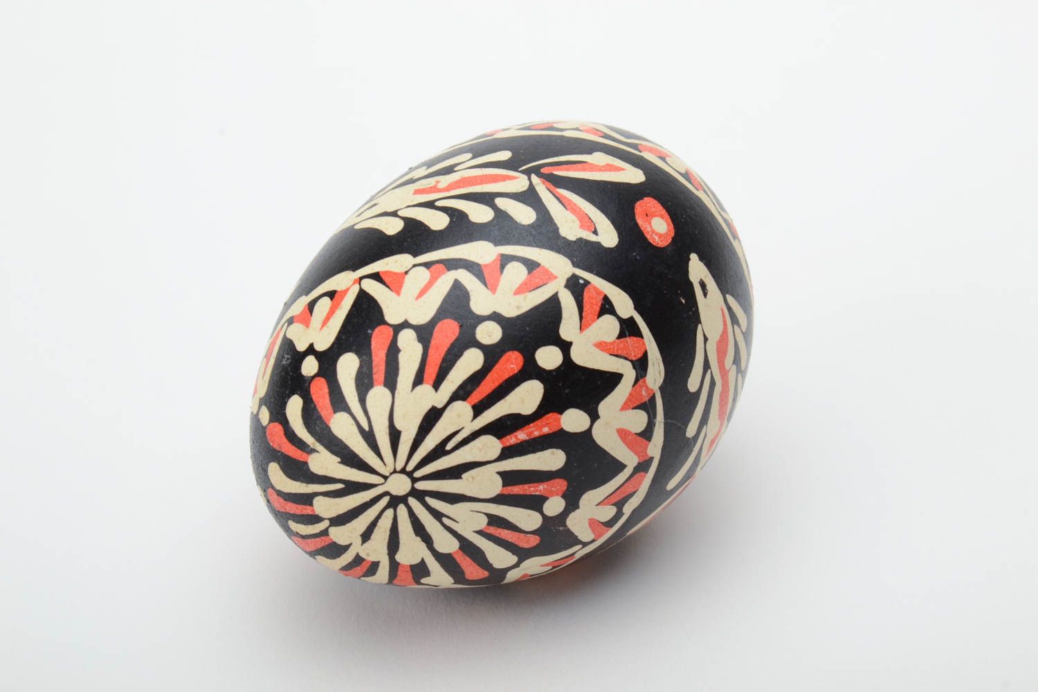 Handmade painted Easter egg of black color with patterns waxing technique photo 2
