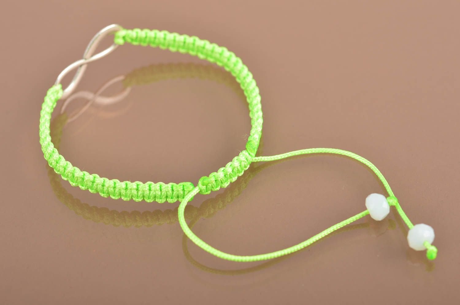 Beautiful handmade woven silk thread bracelet of lime color with metal charm photo 5