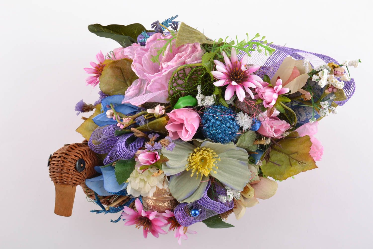 Handmade ikebana made of artificial flowers in wicker basket in the form of duck photo 3