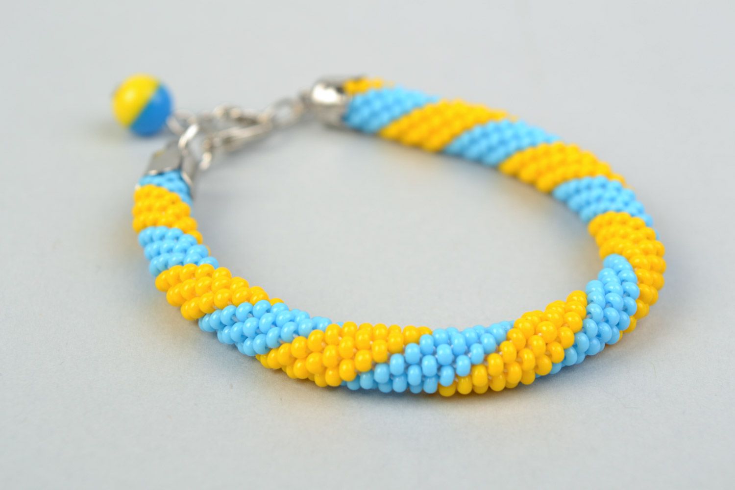 Bright handmade wrist bracelet woven of yellow and blue Czech beads  photo 3