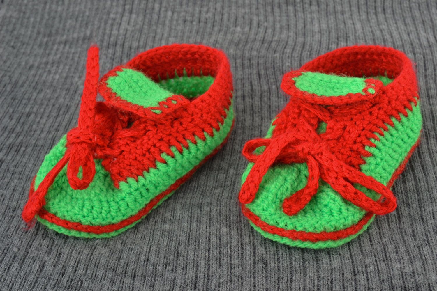 Red and green handmade knitted warm baby booties in the shape of shoes photo 1