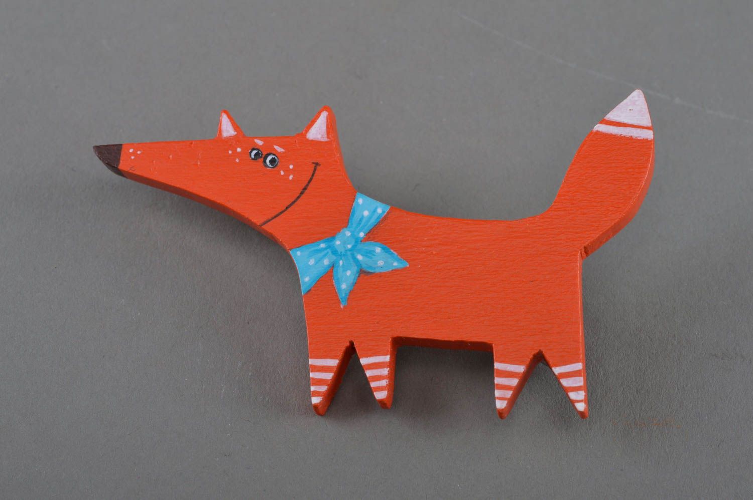 Handmade small painted wooden brooch in the shape of red fox with blue bow photo 1