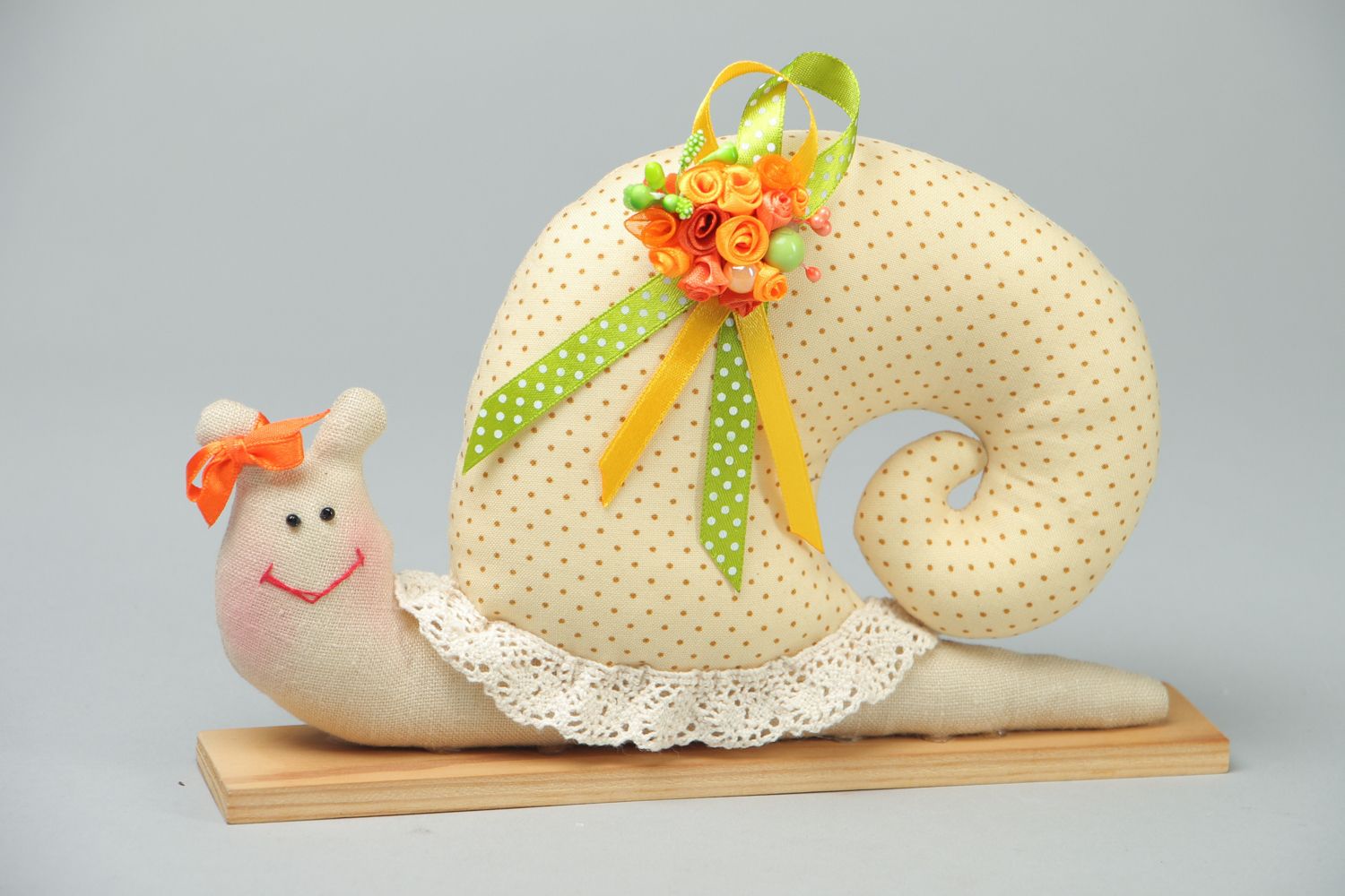 Textile toy snail on wooden holder photo 1