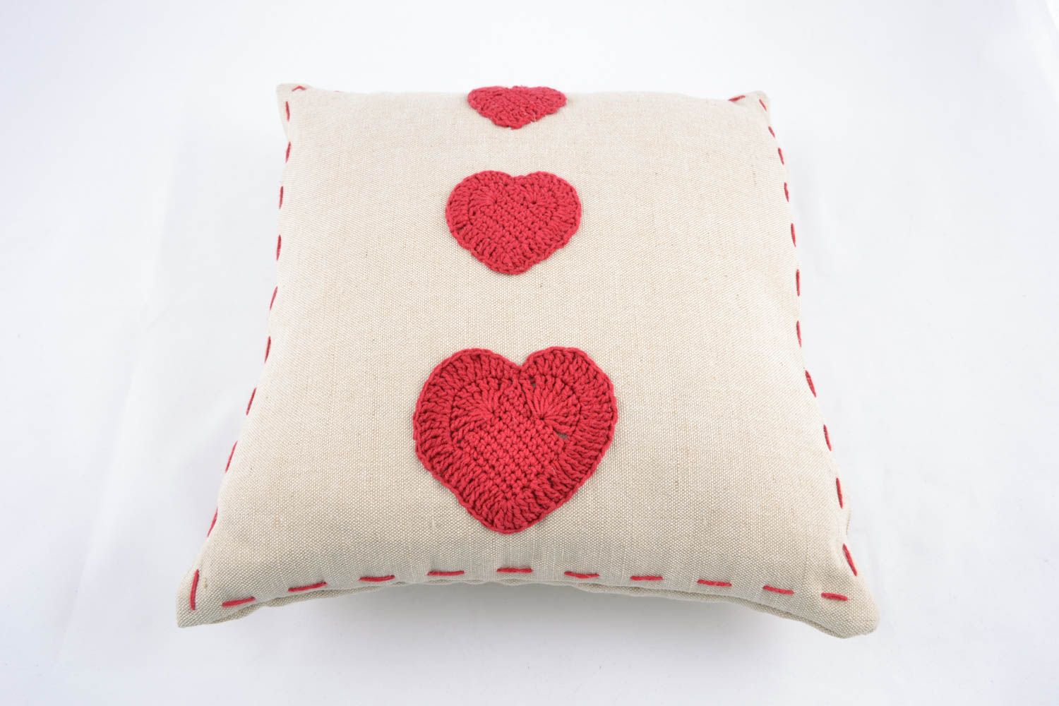 Soft cushion with crochet hearts photo 2