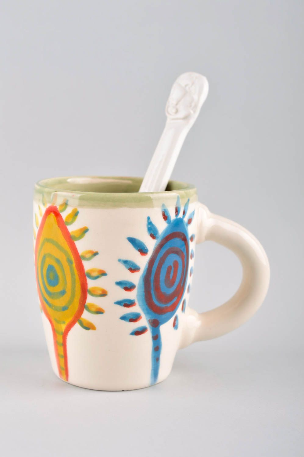 Ceramic glazed cup with ceramic spoon and sun cave pattern photo 2