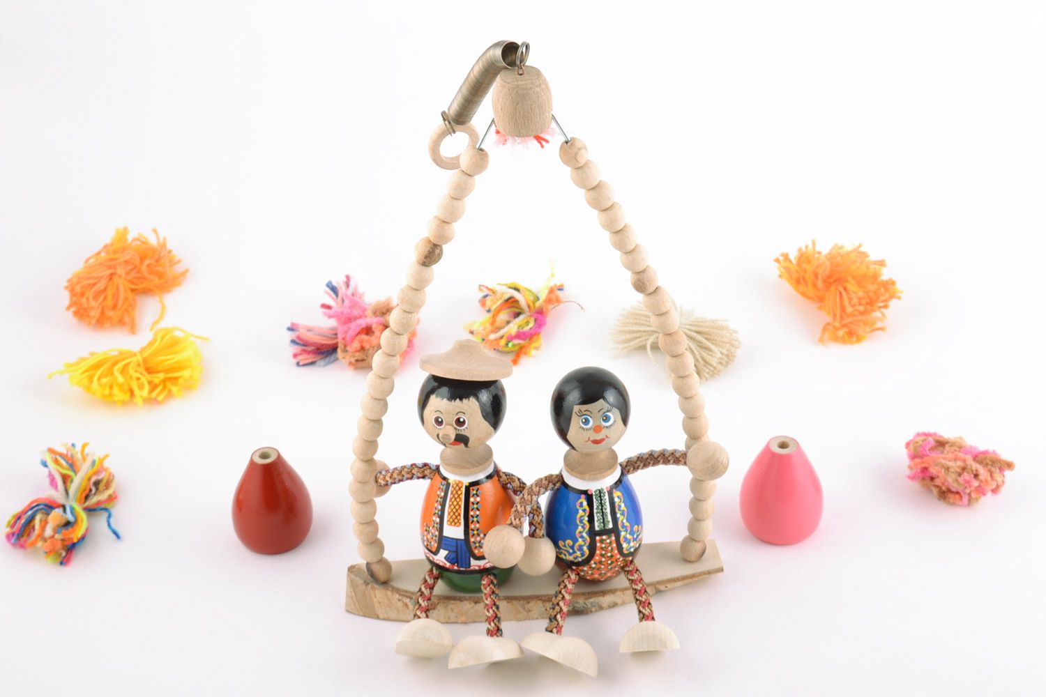 Wooden handmade decorative toy couple on a bench with painting eco-friendly toy photo 1