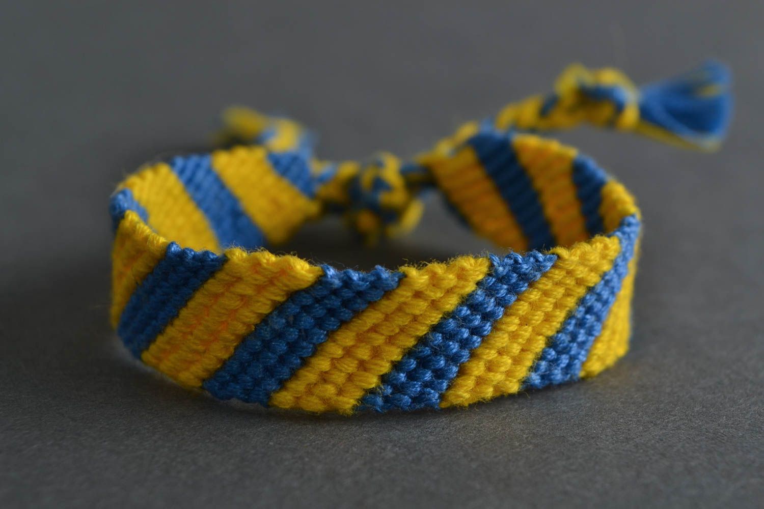 Handmade designer yellow and blue wrist bracelet woven using macrame technique photo 1