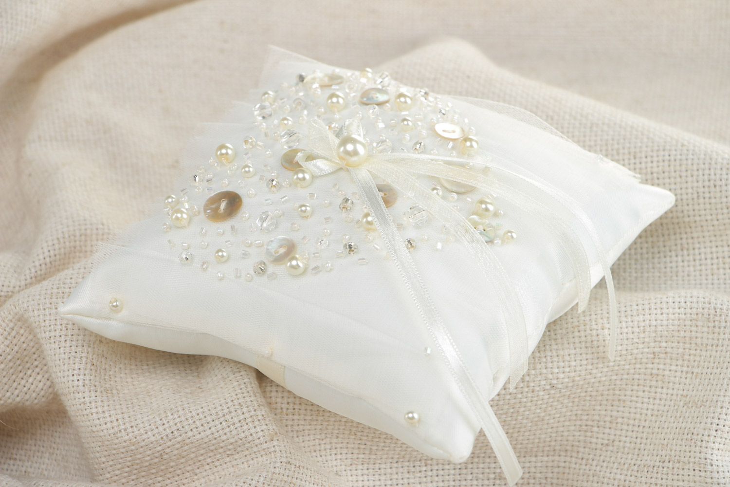 Handmade elegant wedding ring pillow sewn of satin fabric of ivory color photo 1