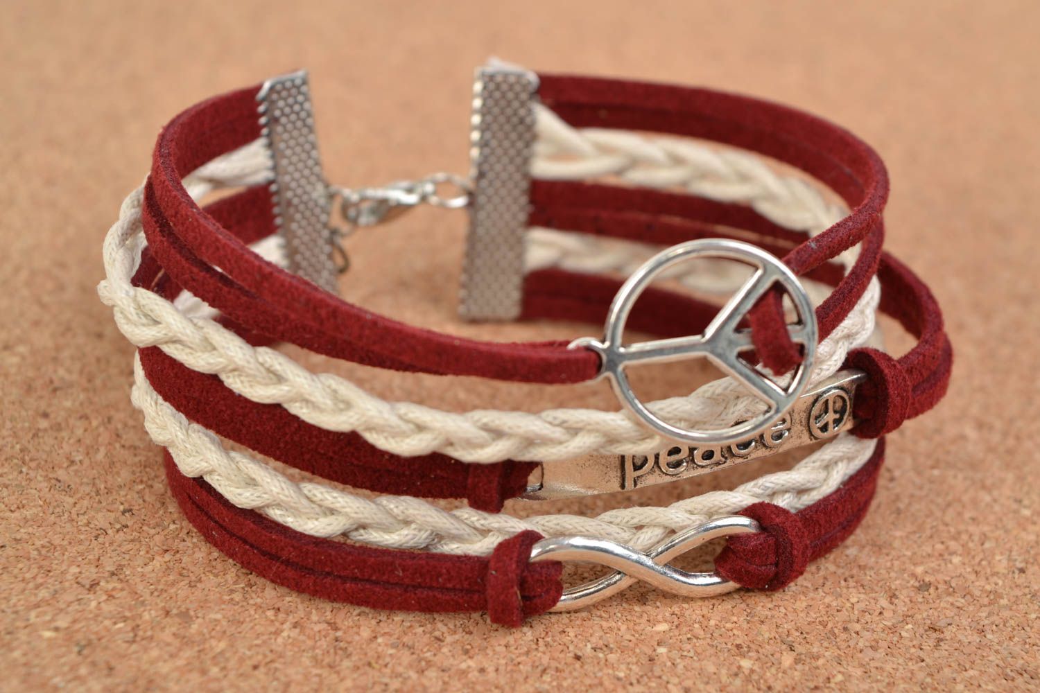 Unusual handmade woven suede bracelet with charms in the shape of various signs photo 1