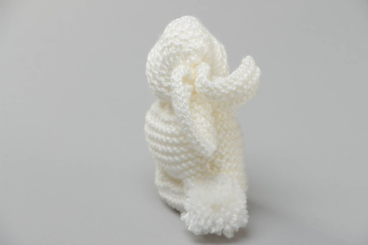 Handmade small soft toy knitted of white acrylic threads in the shape of rabbit photo 4