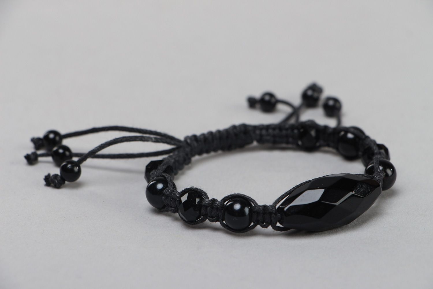 Black designer bracelet hand made of beads and cord photo 2