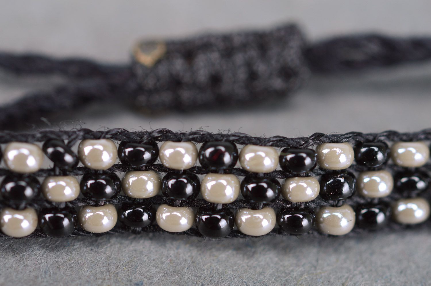 Handmade wrist bracelet woven of black and nacre beads with ties for women photo 4