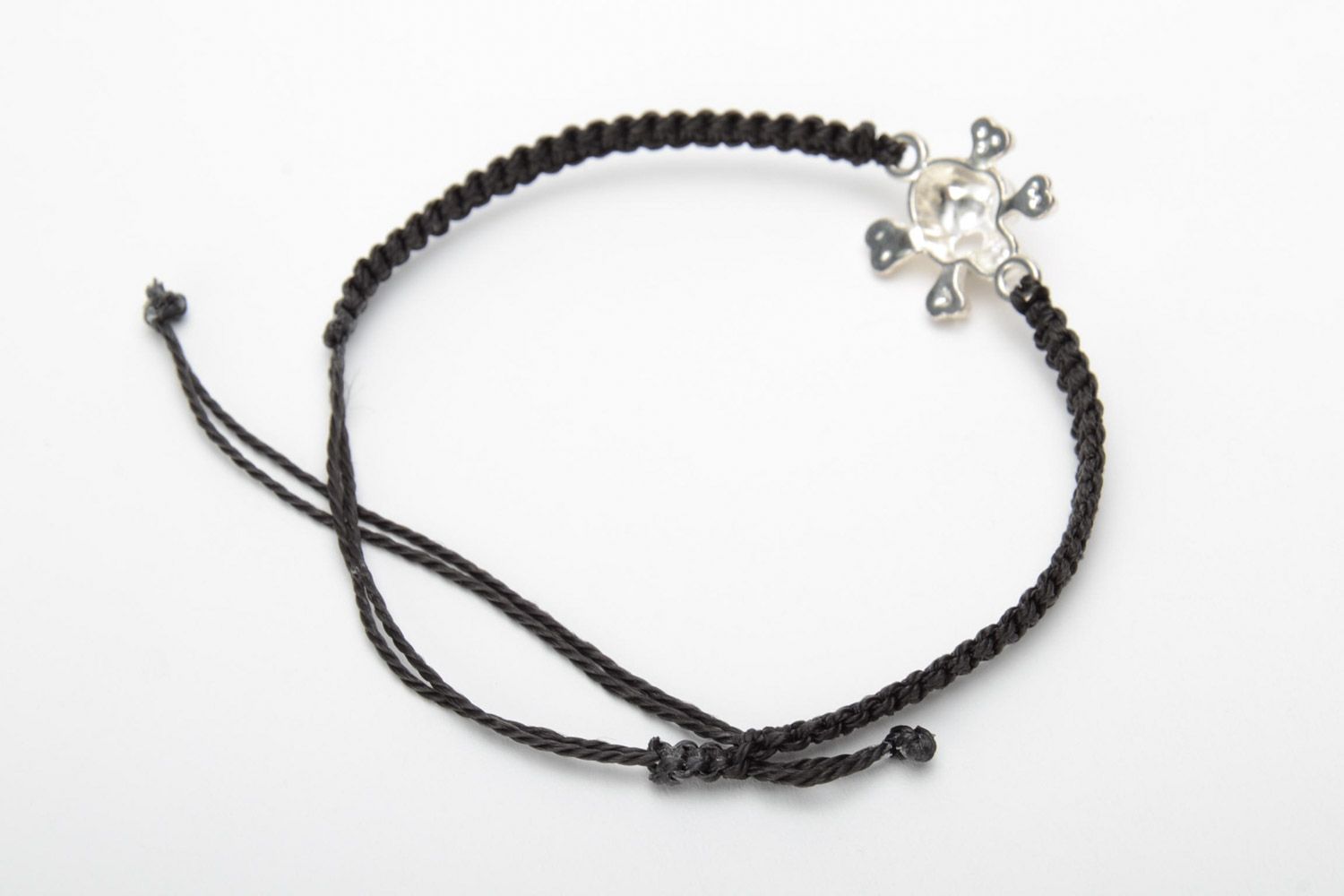 Handmade black woven capron thread wrist bracelet with metal charm in the shape of skull photo 4