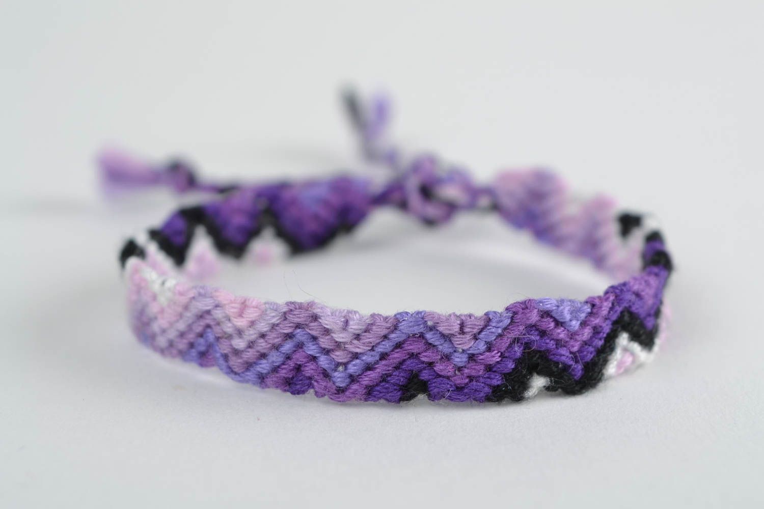 Handmade thin friendship wrist bracelet woven of threads in violet color shades photo 3