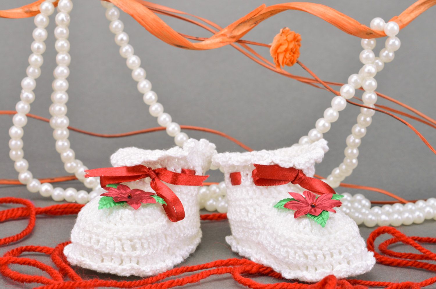 Handmade crocheted white baby booties made of cotton with a flower for a baby girl photo 1