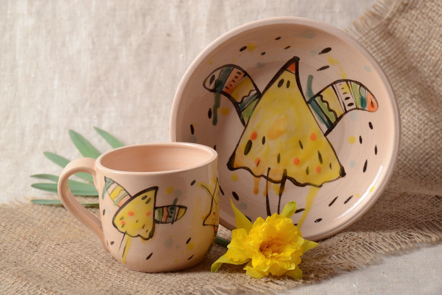 Handmade ceramic kids' tea set of a cup and plate in beige color with a funny pattern photo 1