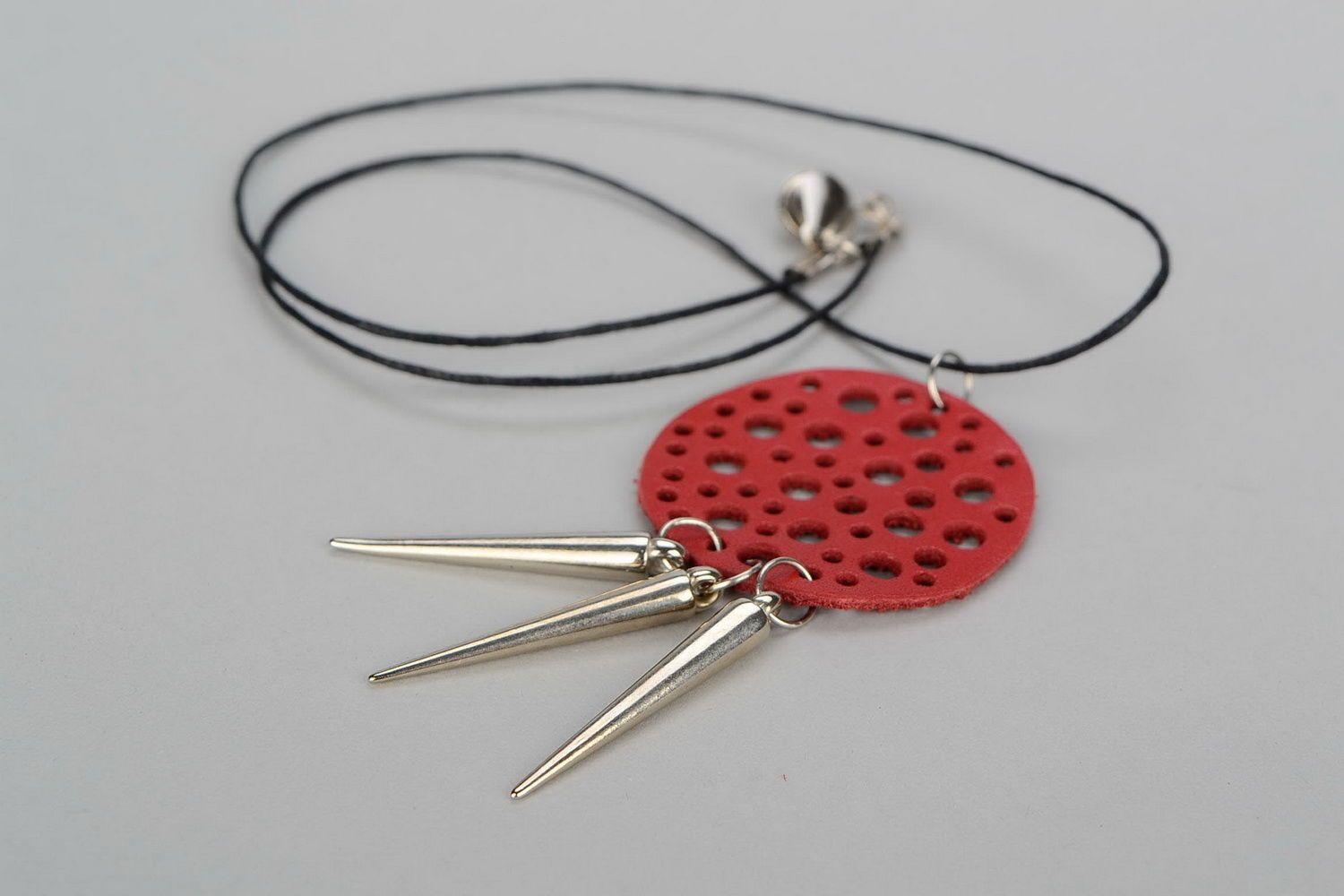 Pendant made of natural leather with studs photo 2