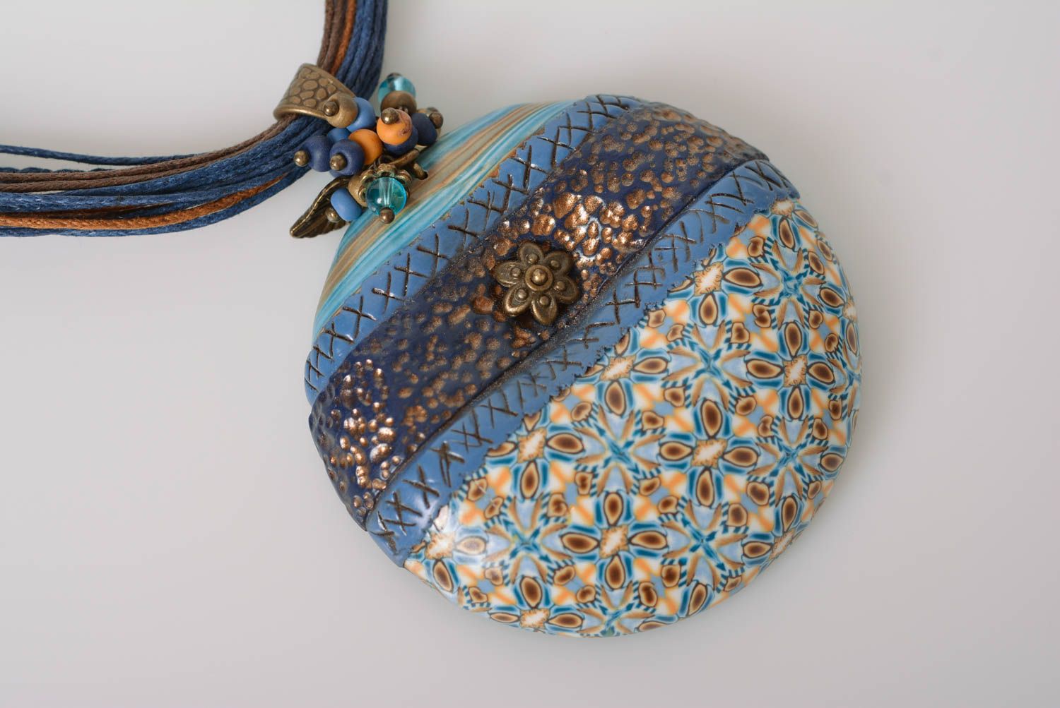 Handmade round ornamented blue polymer clay pendant on colorful waxed cords photo 3