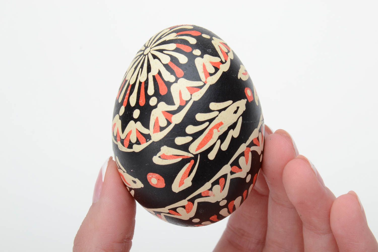 Handmade painted Easter egg of black color with patterns waxing technique photo 5