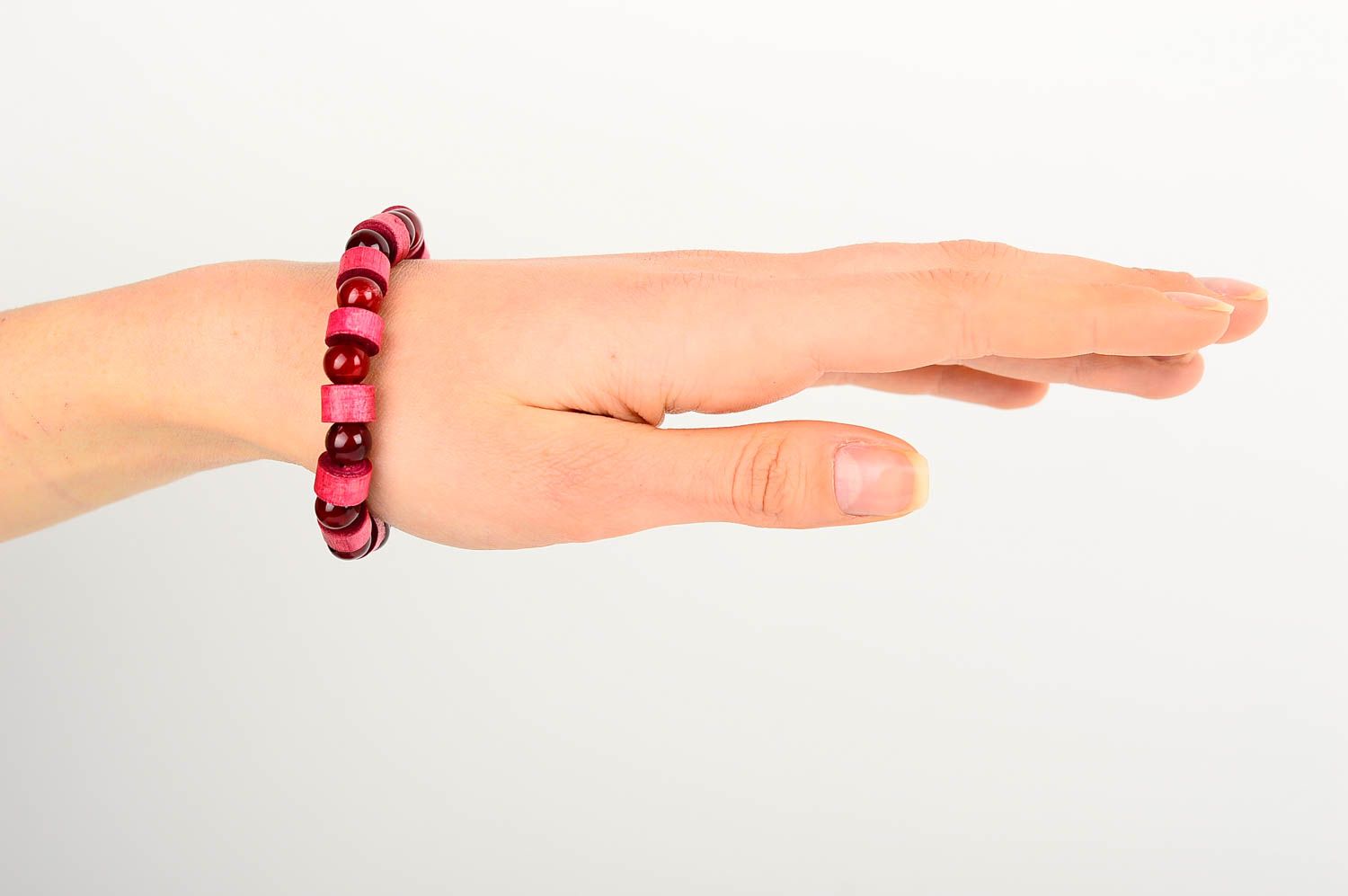 The wide wooden handmade beaded bracelet with dark red and light red beads on elastic cord photo 2