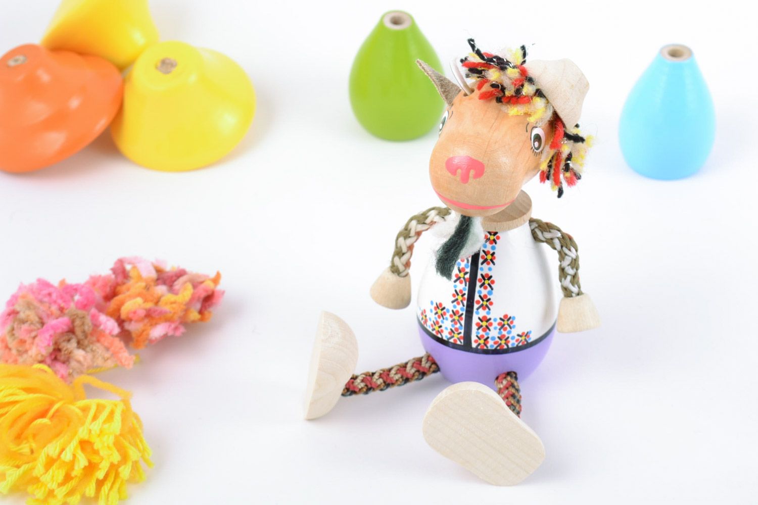 Handmade painted eco friendly wooden toy goat in ethnic costume for kids photo 1