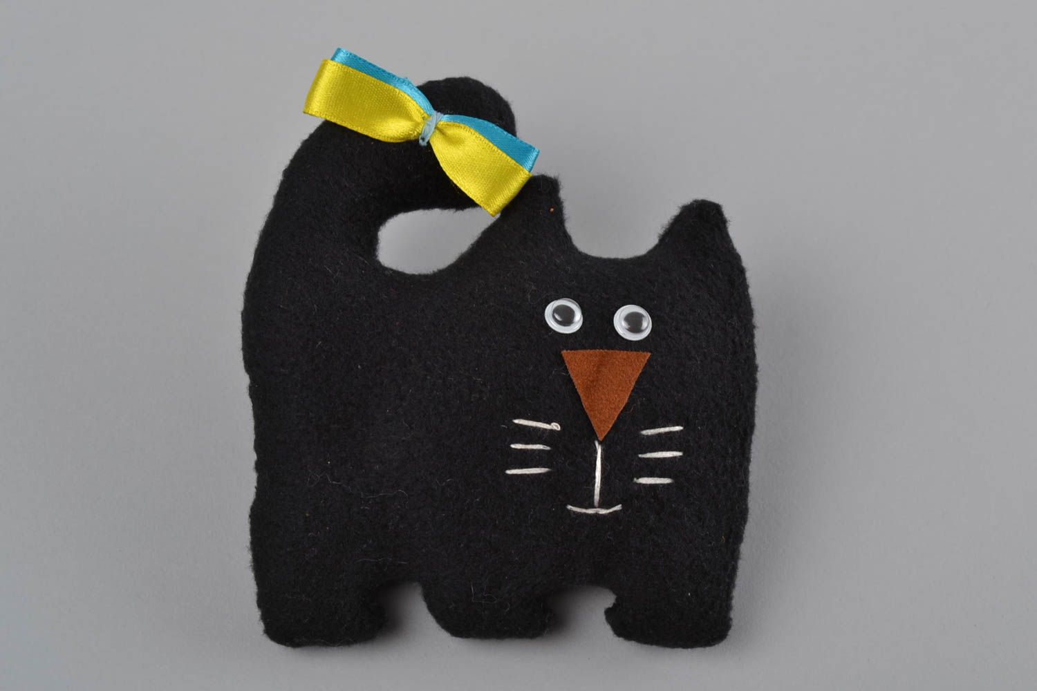 Handmade black soft toy cat made of fleece with colorful bow photo 3
