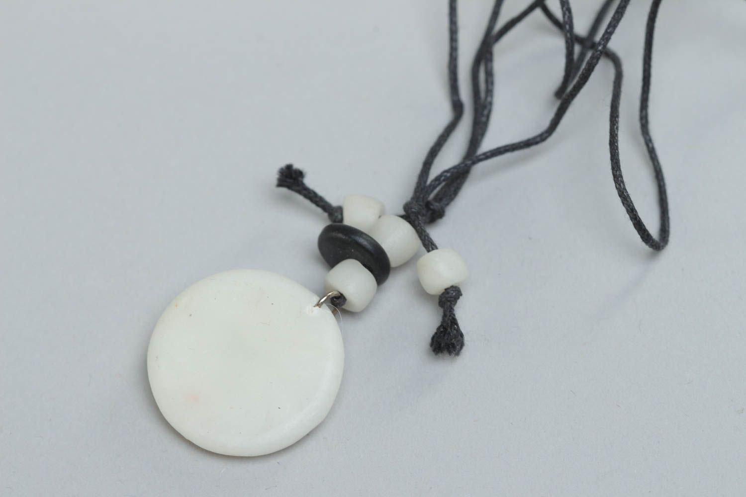 Handmade designer round pendant made of polymer clay with ethnic pattern on cord photo 4