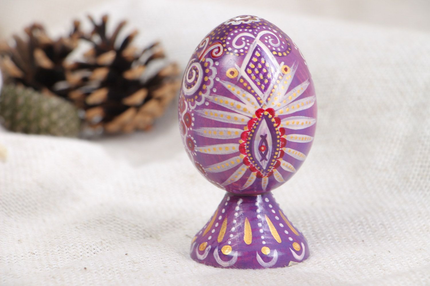 Handmade painted wooden Easter egg of lilac color in ethnic style photo 1