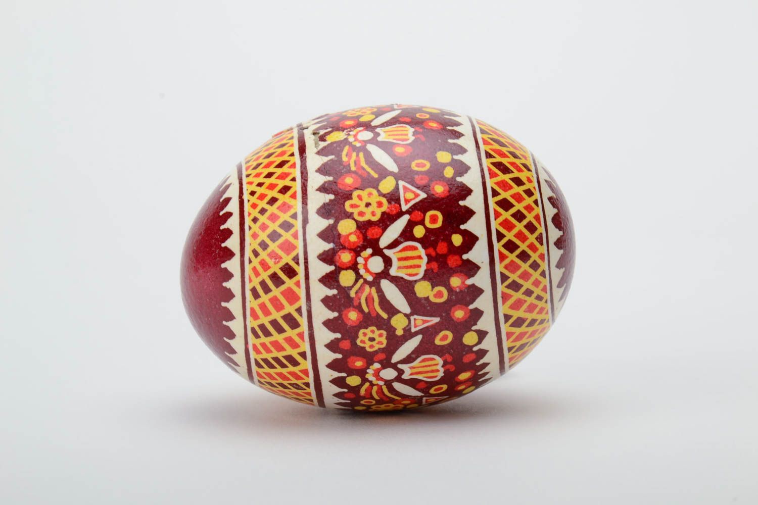 Red and yellow handmade designer painted Easter egg created using waxing technique photo 3