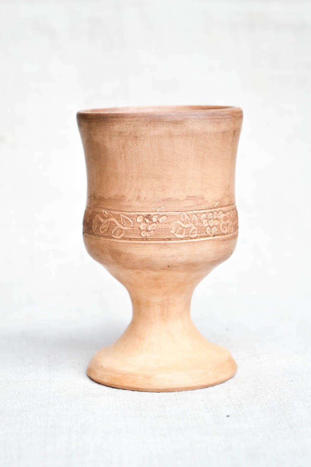 Light brown clay rustic drinking cup on stand with simple plain floral pattern photo 5