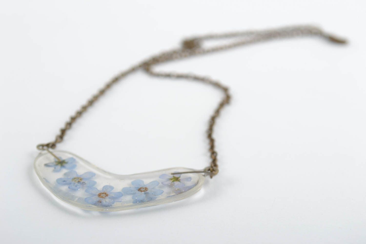 Tender handmade transparent epoxy resin pendant with blue flowers on metal chain photo 4