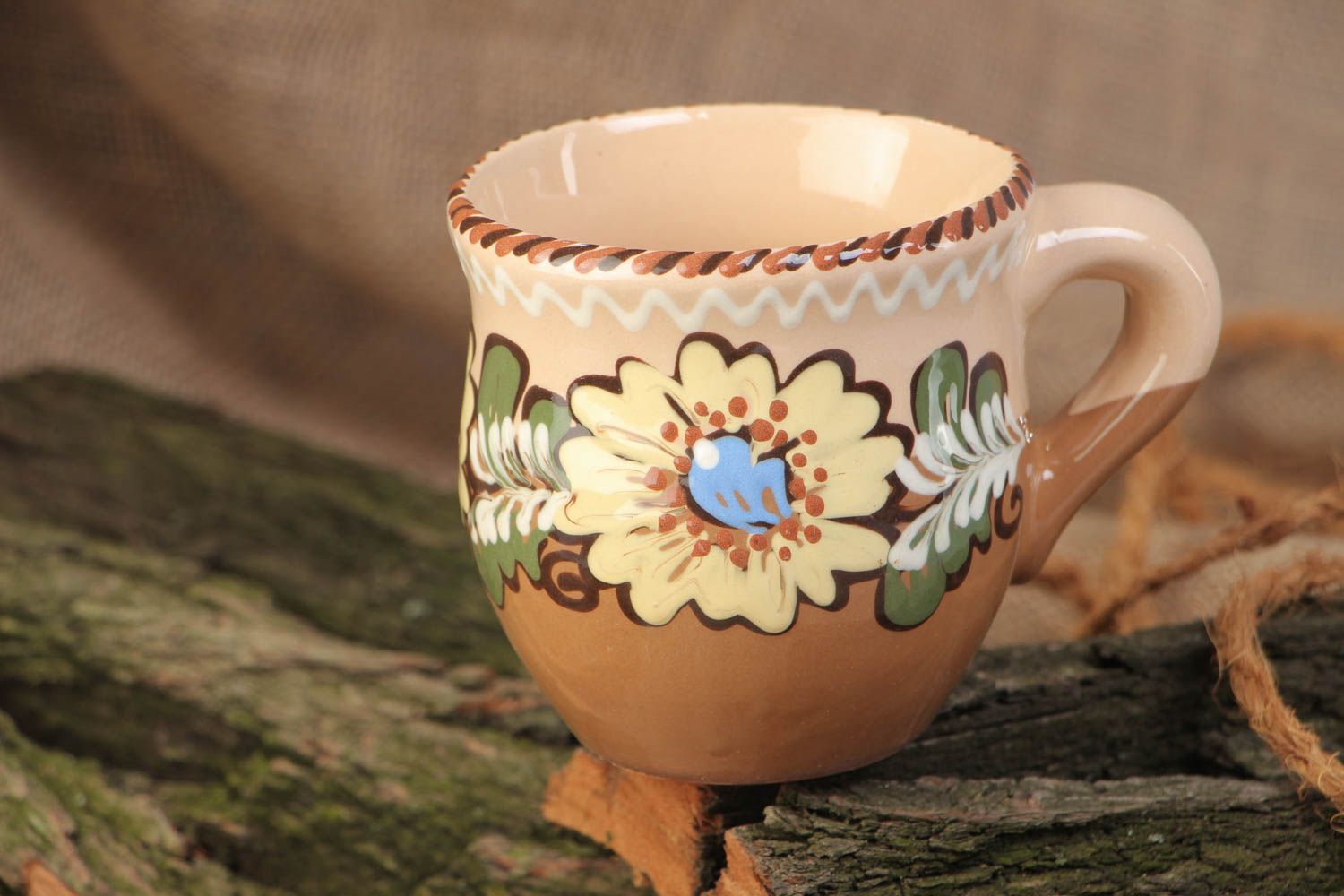 10 oz clay glazed cup with handle and floral design in brown, beige, and blue color photo 1