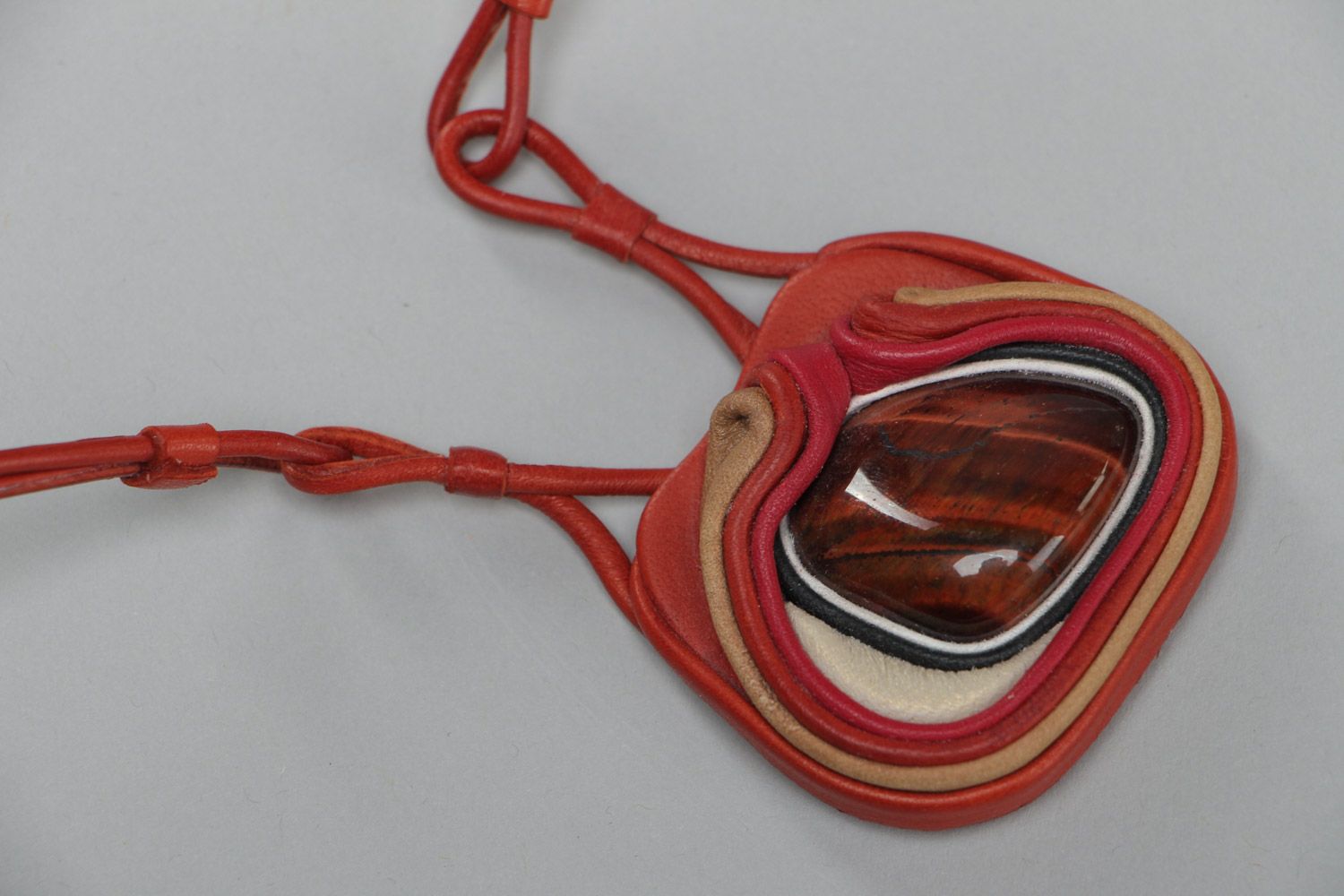 Handmade stylish designer pendant made of genuine leather with red stone  photo 2