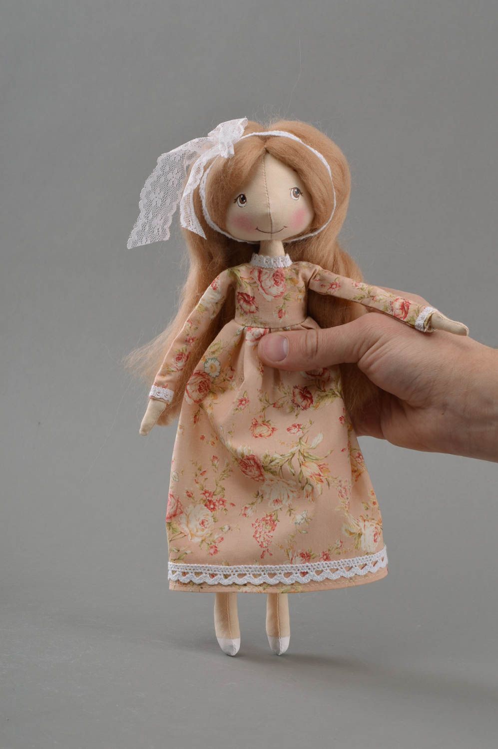 Handmade cute toy doll made of fabric in dress with flower print on stand photo 4