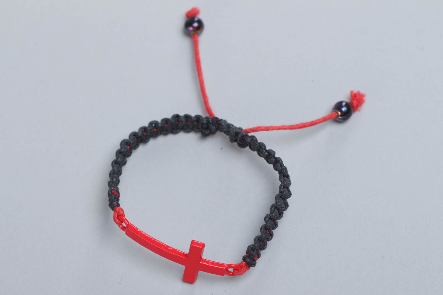 Unusual handmade black woven friendship bracelet with cross charm photo 2