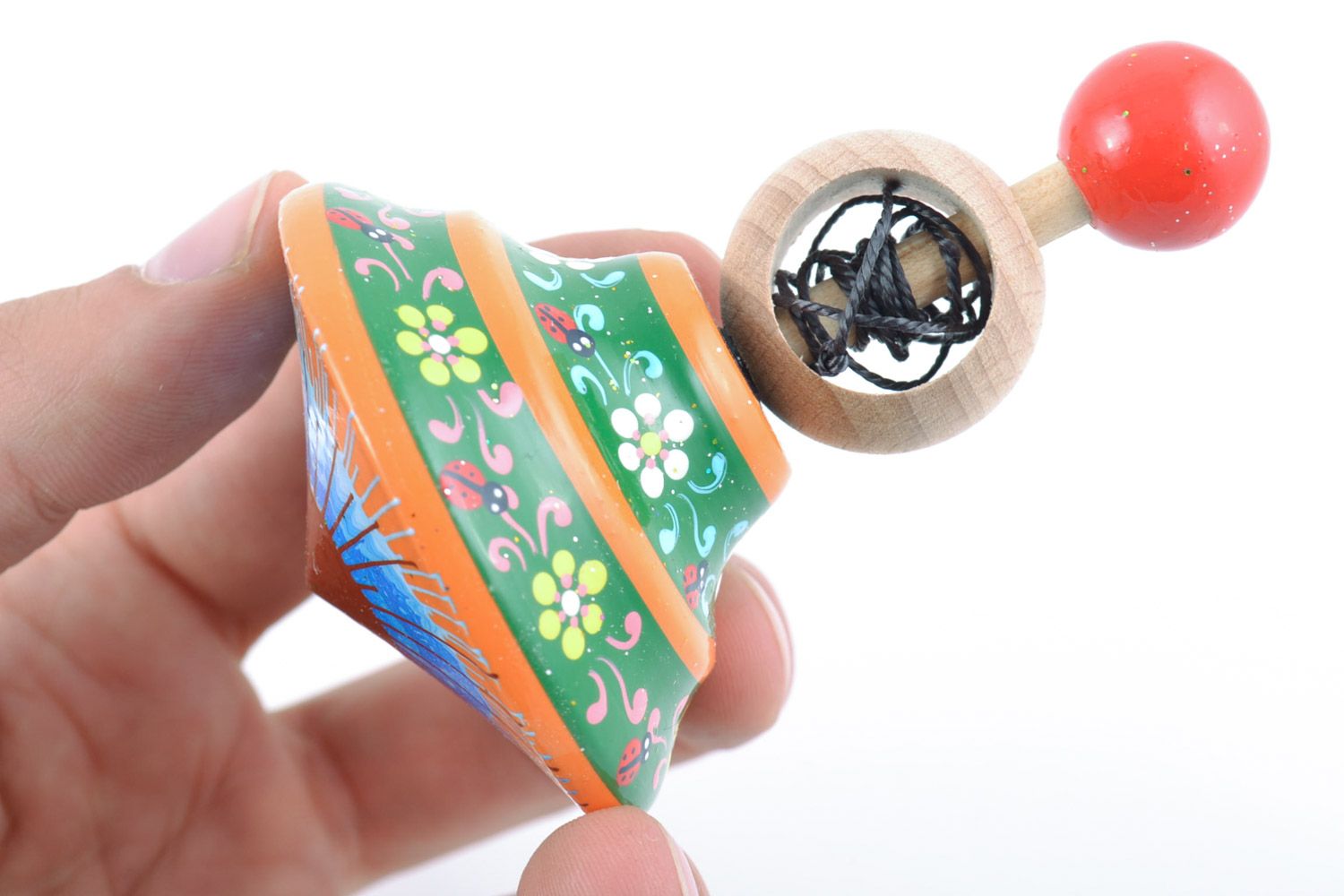Homemade wooden ornamented toy spinning top painted with eco dyes for children photo 2