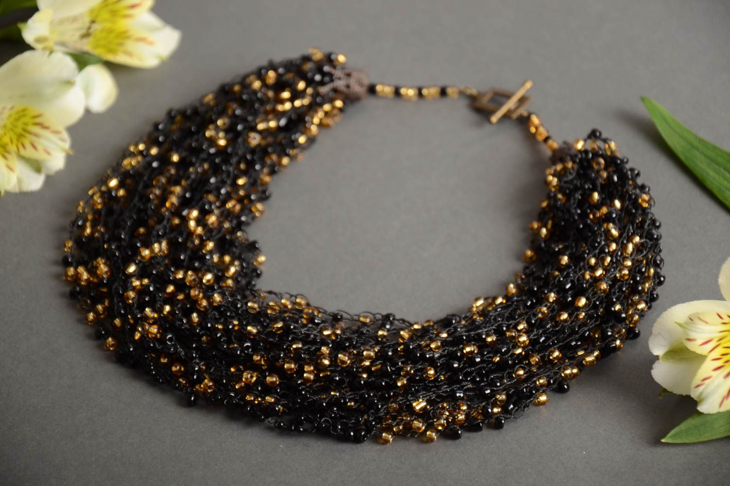 Handmade long massive necklace crocheted of black and golden Czech beads photo 1