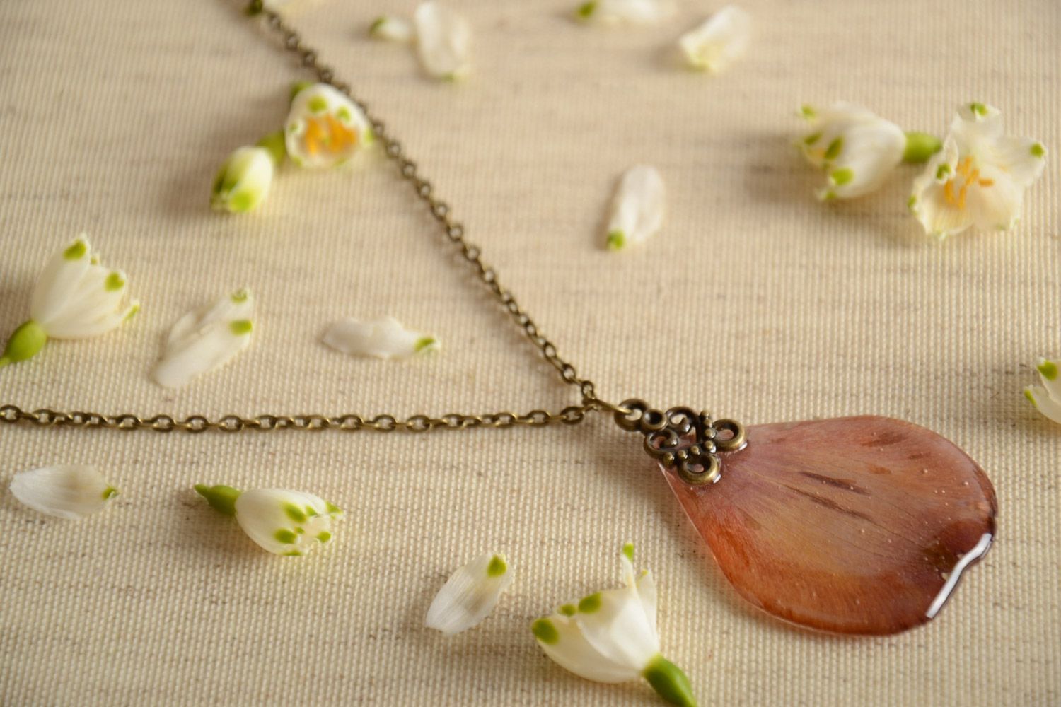 Homemade neck pendant on long chain with flower petal coated with epoxy photo 1