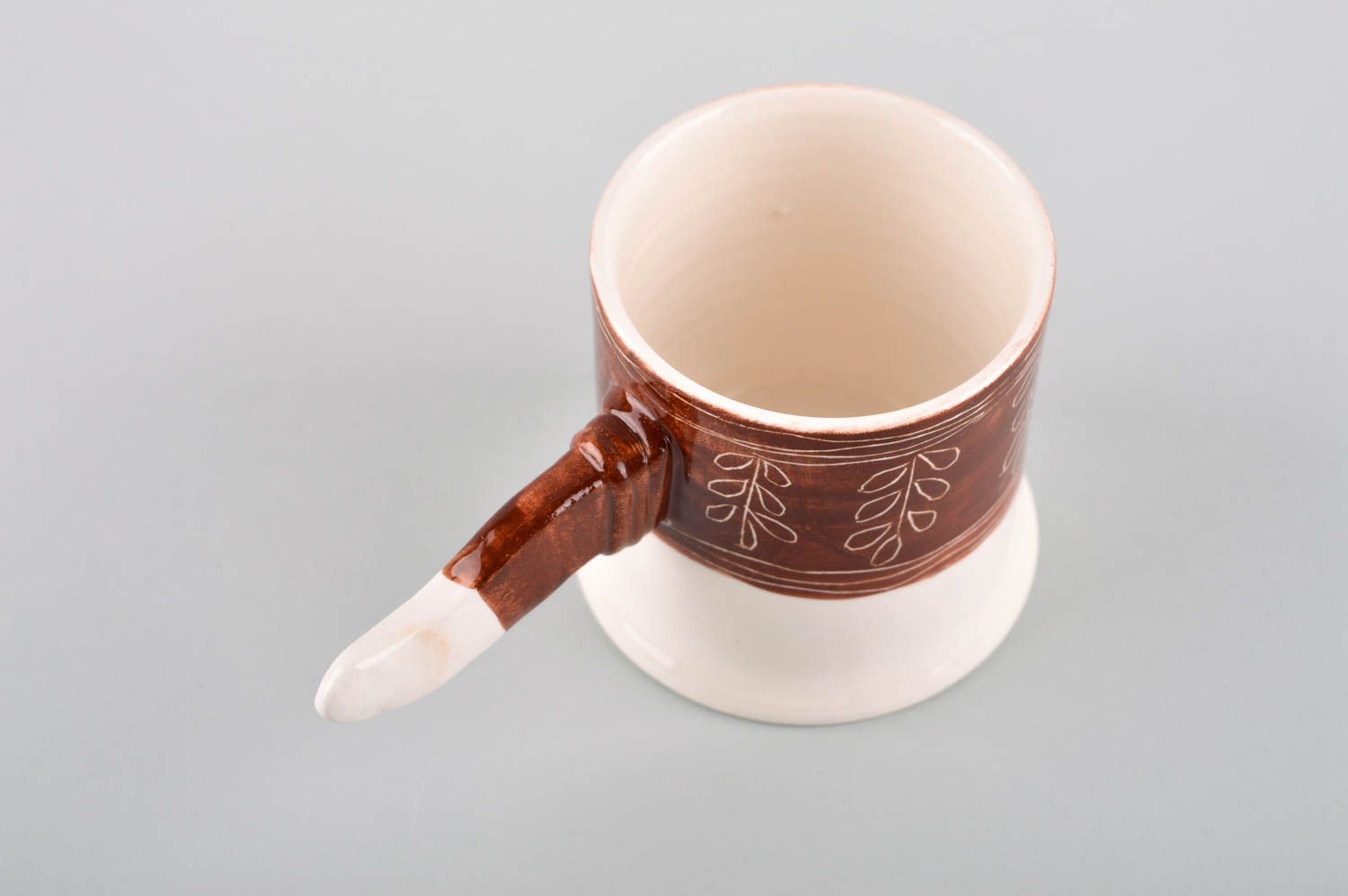 Teacup in white and brown cherry colors and non-standard handle in the shape of a stick photo 3