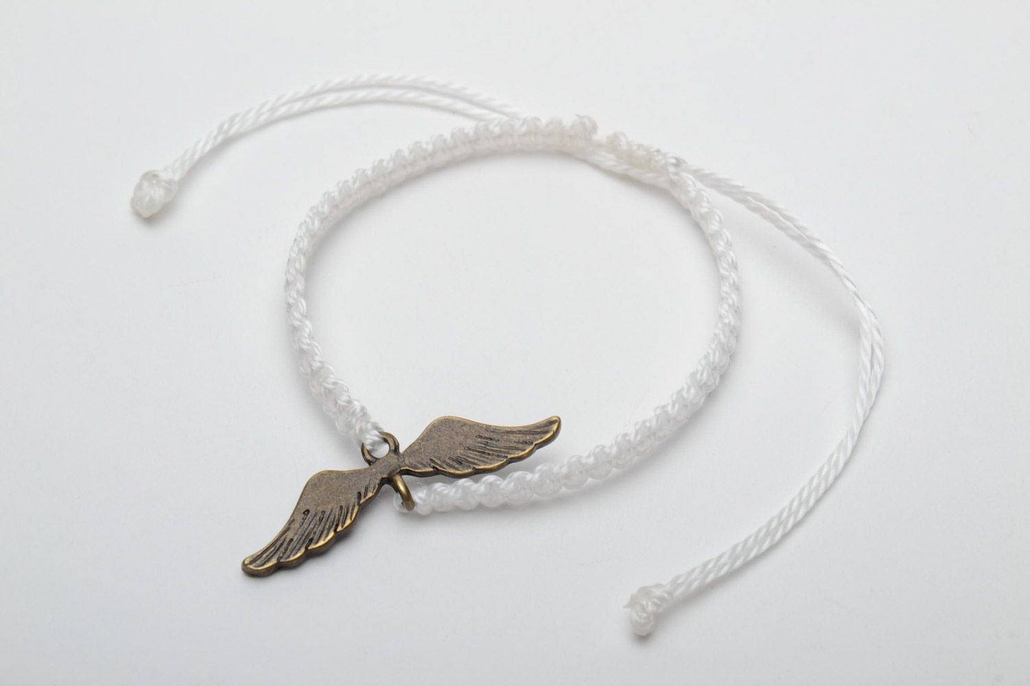 Handmade white women's woven thread bracelet with metal charm photo 3