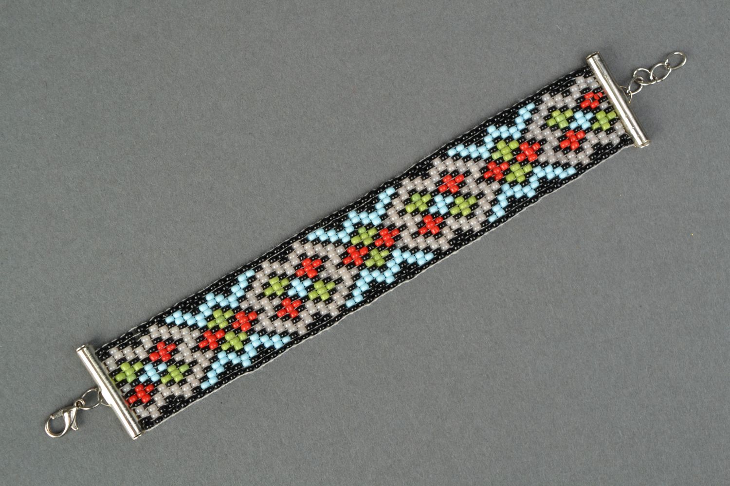 Ethnic ornament wide beaded bracelet in black, red, green, gray color photo 1