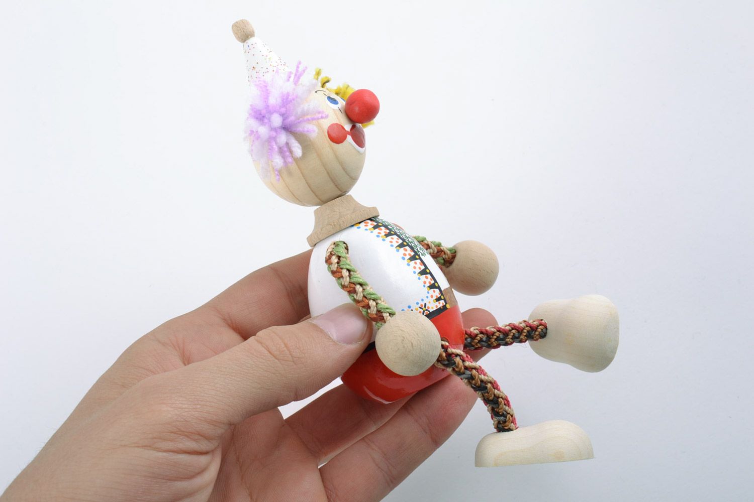 Bright designer homemade painted wooden toy in the shape of clown  photo 2
